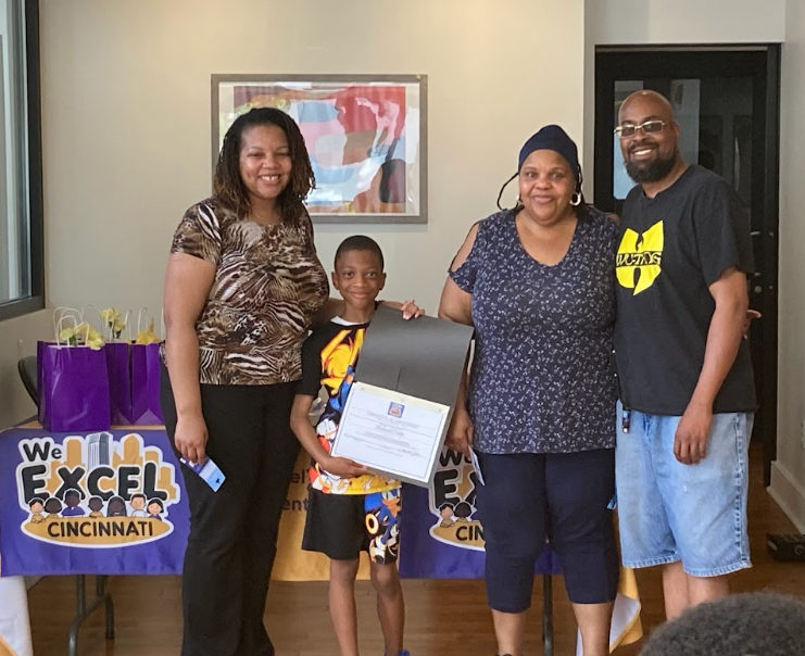 A student and family celebrating a Read to Rise milestone