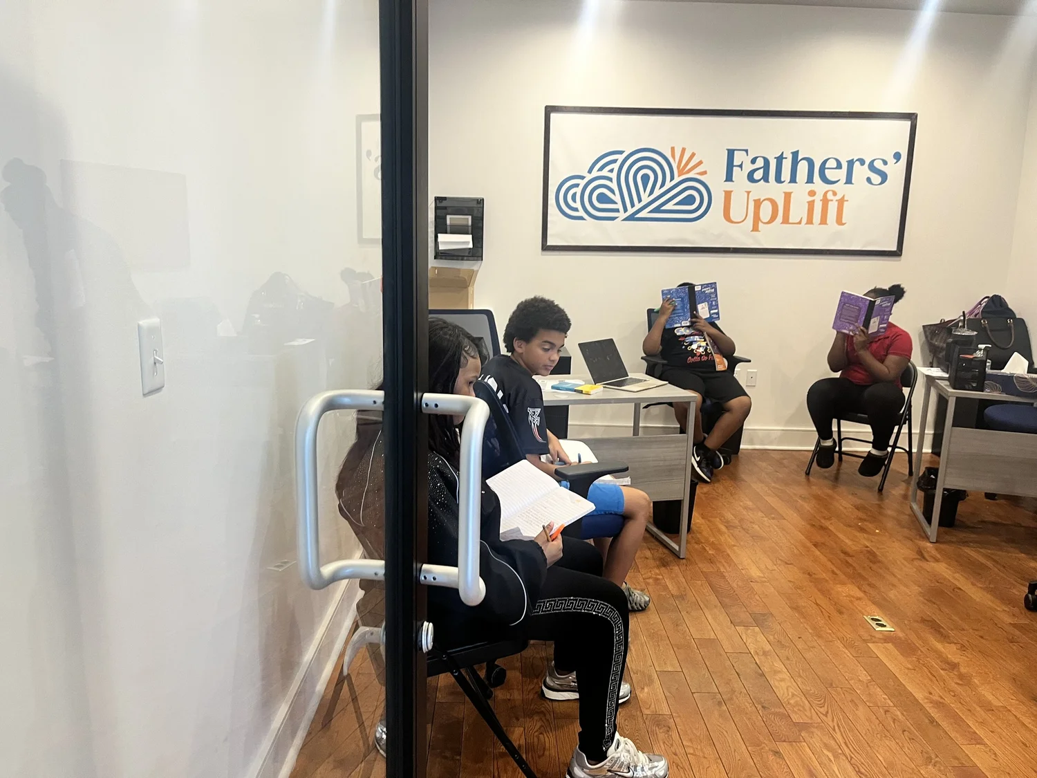 Students reading at the Fathers' UpLift community partner space