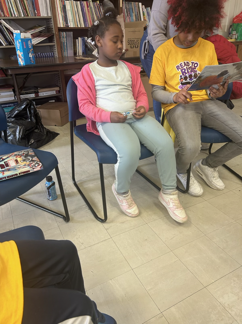 A staff member celebrating with two students